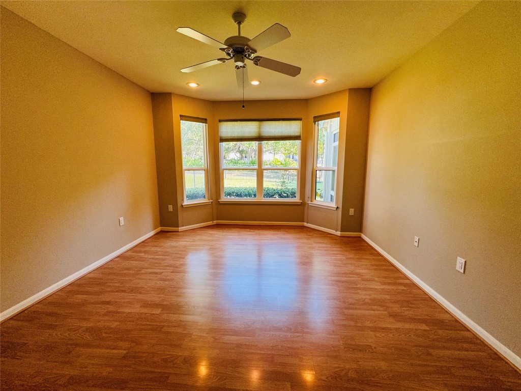 127 Verbena Drive Georgetown, TX 78633 - Photo 6 of 12 a view of an empty room with window and wooden floor