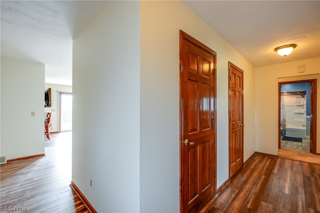 13920 Kneisel Road Vermilion, OH 44089 - Photo 6 of 35 Hallway featuring dark hardwood / wood-style floors