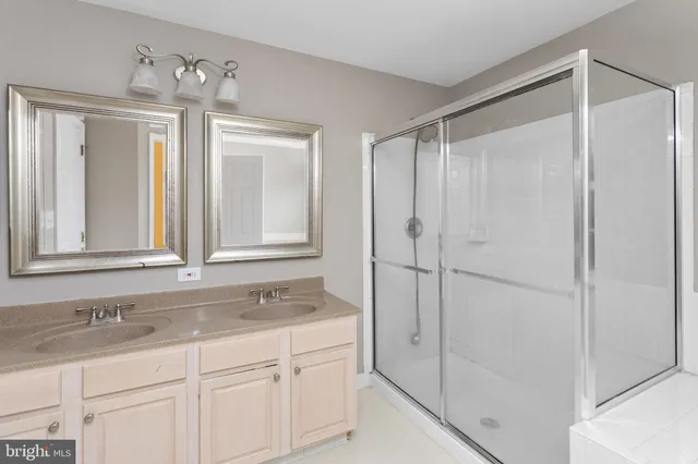 a bathroom with a granite countertop sink mirror and double