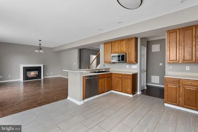 a kitchen with granite countertop a stove top oven and sink