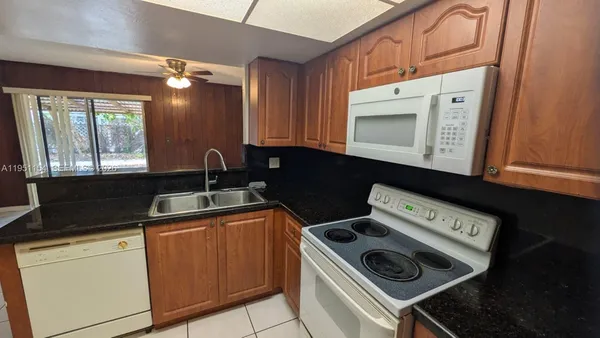 a kitchen with a stove microwave and sink