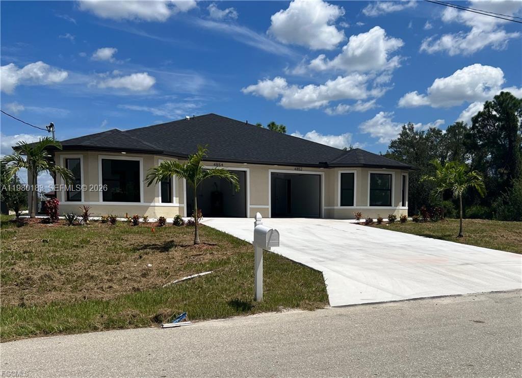4854 30th Street Southwest, Unit 4854 Lehigh Acres, FL 33973 - Photo 1 of 11 front view of a house with a yard