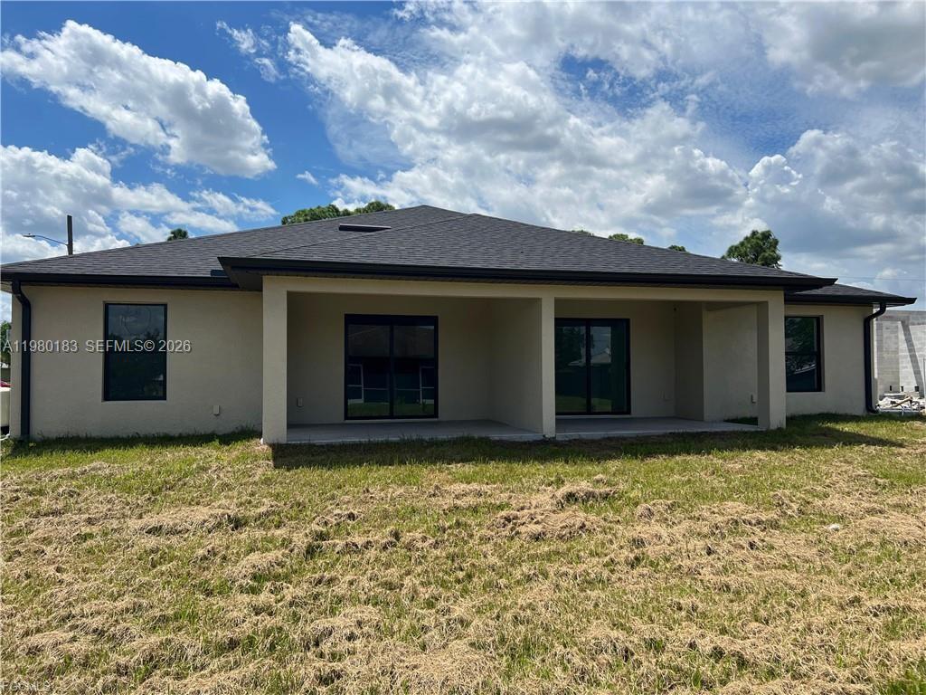 4854 30th Street Southwest, Unit 4854 Lehigh Acres, FL 33973 - Photo 11 of 11 a view of a house with a garden