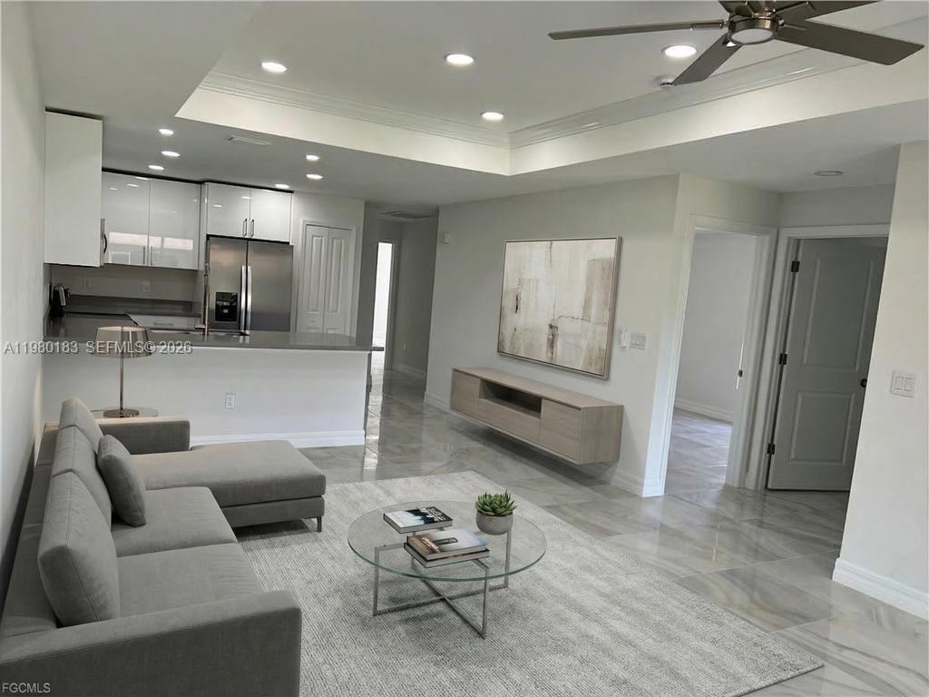 4854 30th Street Southwest, Unit 4854 Lehigh Acres, FL 33973 - Photo 4 of 11 a living room with furniture and kitchen view