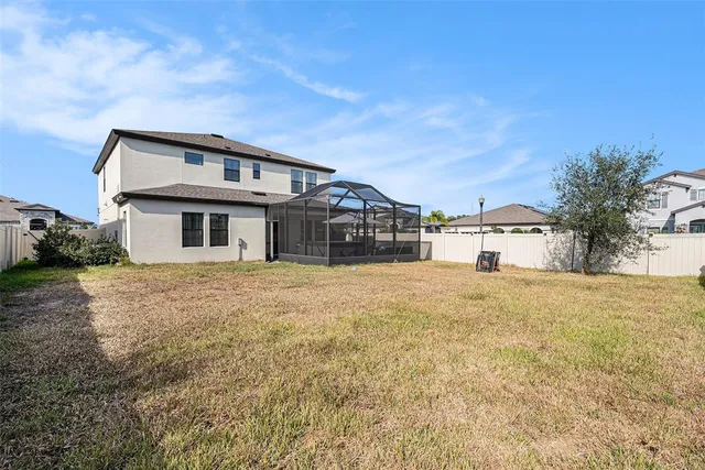 a front view of a house with a large trees