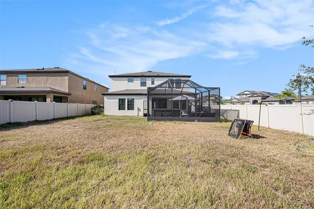 a view of a house with a backyard