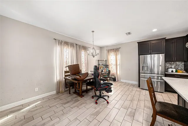 a work room with furniture a flat screen tv and a window