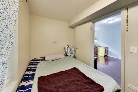 a bedroom with a bed and mirror