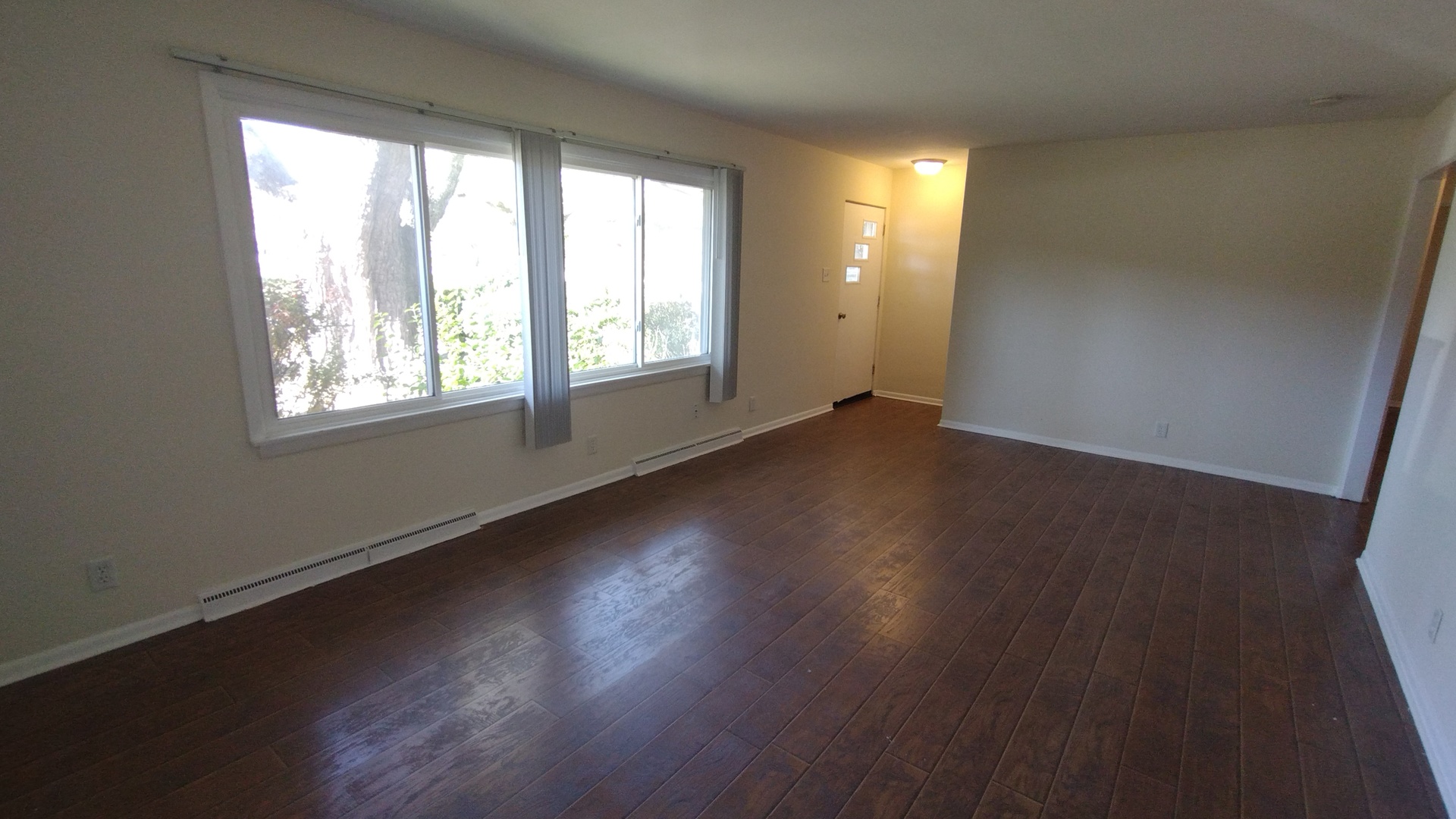 18315 Argyle Avenue Homewood, IL 60430 - Photo 4 of 19 an empty room with wooden floor and windows