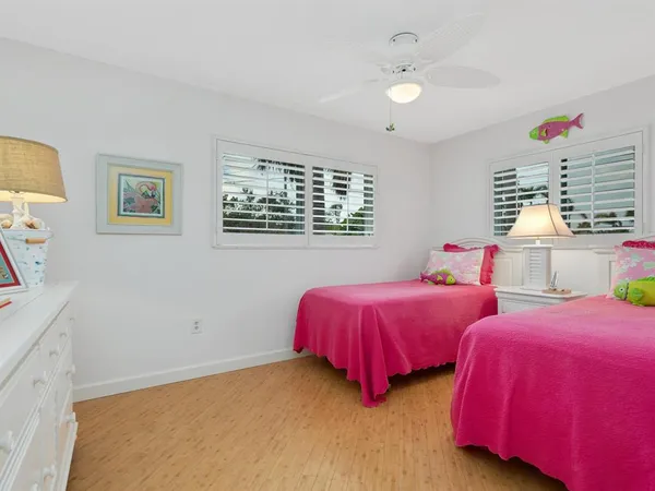 a bedroom with two beds and a chandelier