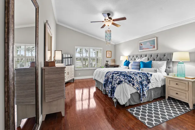 a bedroom with bed and wooden floor