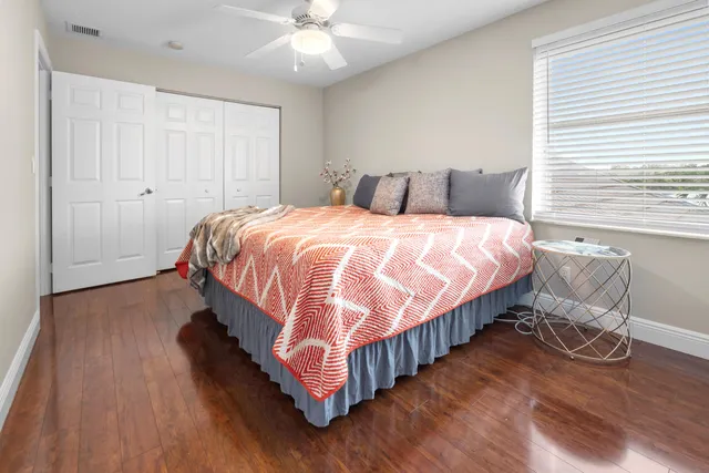 a bedroom with a bed and wooden floor