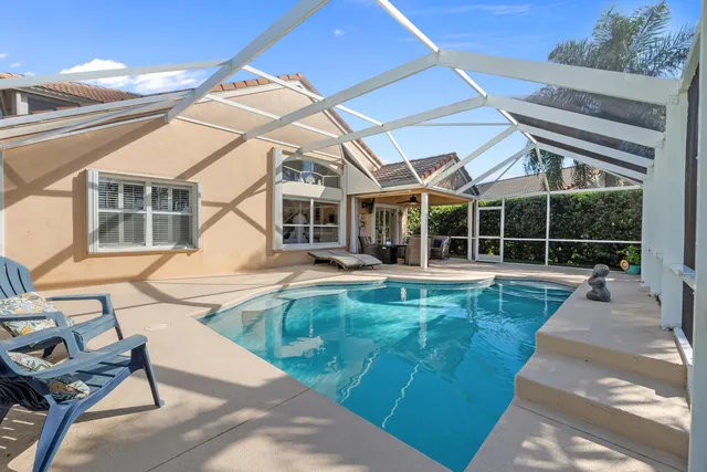 a view of a house with backyard porch and sitting area
