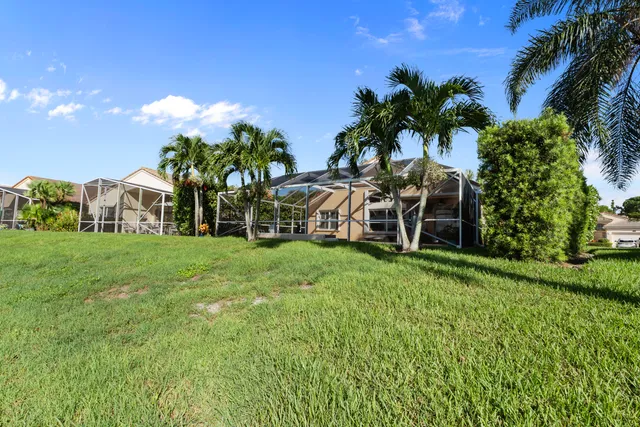 a view of a house with a backyard