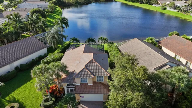 an aerial view of a house with a yard and potted plants