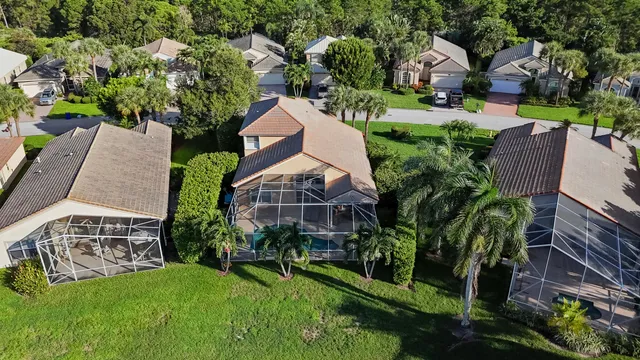 an aerial view of a house with a yard