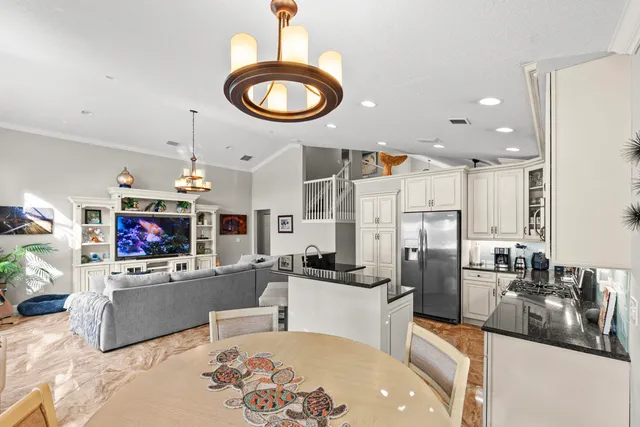a kitchen with stainless steel appliances a sink a stove and a refrigerator