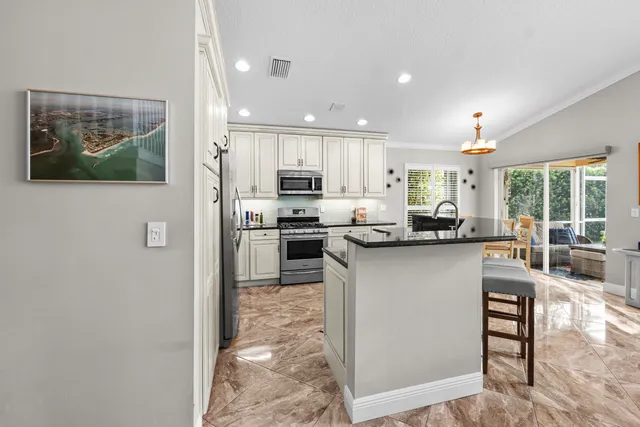 a kitchen with stainless steel appliances a refrigerator and a stove top oven