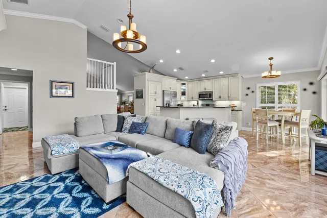 a living room with furniture and a chandelier