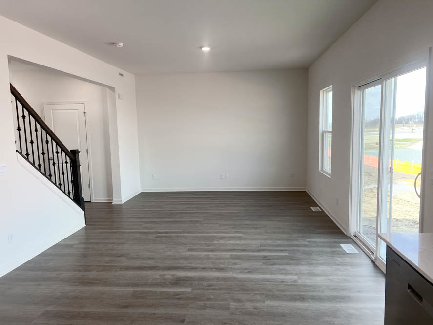 2501 Semillon Street Oswego, IL 60543 - Photo 2 of 21 a view of an empty room with wooden floor and a window
