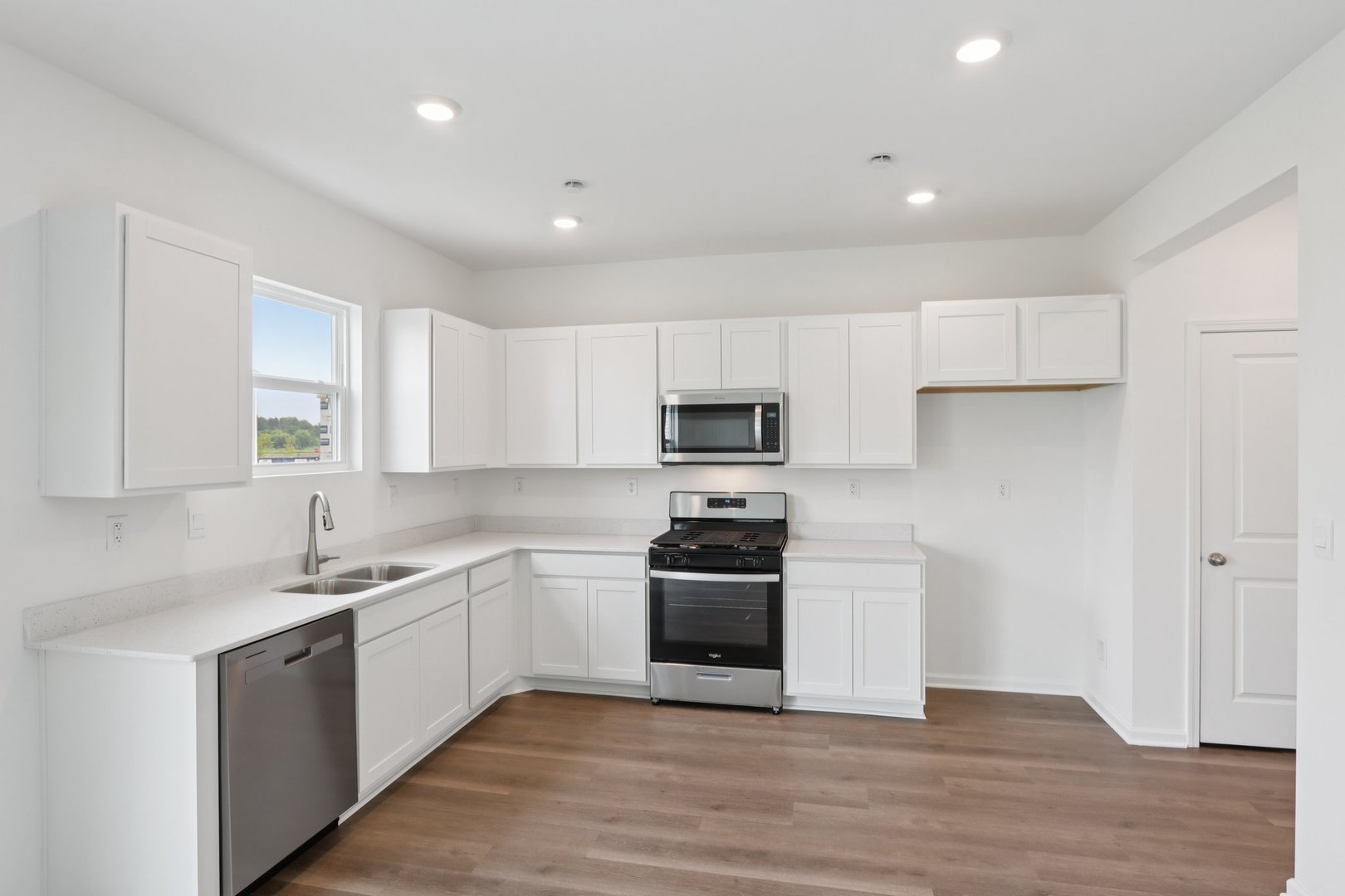2501 Semillon Street Oswego, IL 60543 - Photo 4 of 21 a kitchen with cabinets stainless steel appliances and a sink