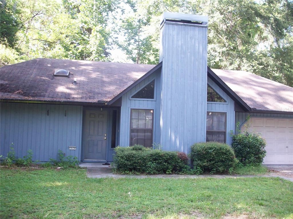 2624 Northwest 4th Avenue Gainesville, FL 32607 - Photo 1 of 14 a backyard of a house with lots of green space