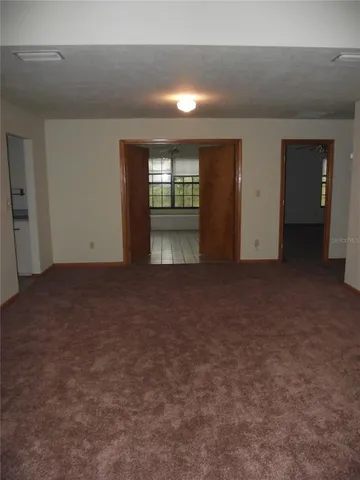an empty room with closet and wooden floor