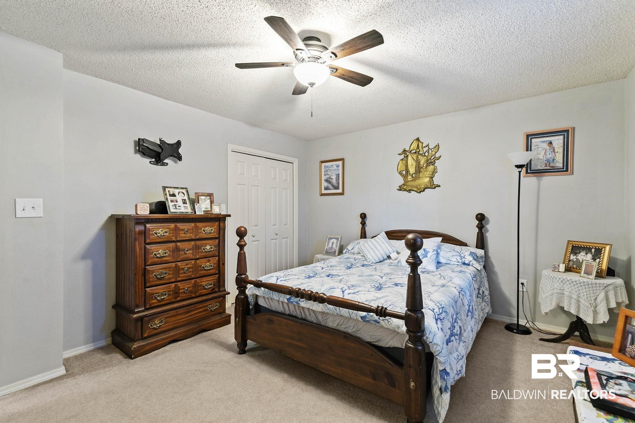 1510 South Juniper Street Foley, AL 36535 - Photo 23 of 36 Bedroom featuring light colored carpet, a ceiling fan, a closet, and a textured ceiling