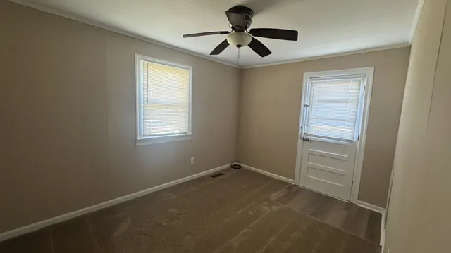 a view of room with window and ceiling fan