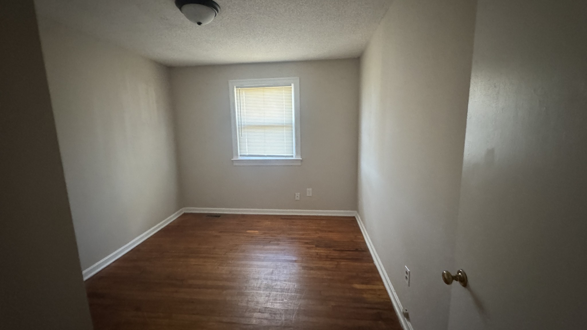 3038 Old Sango Road Clarksville, TN 37043 - Photo 9 of 9 an empty room with wooden floor and windows