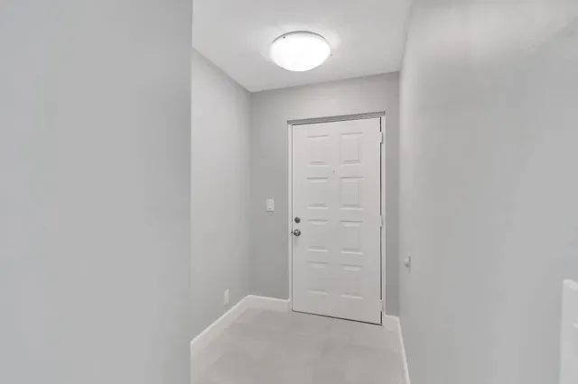 a kitchen with stainless steel appliances white cabinets white stove a microwave and a refrigerator