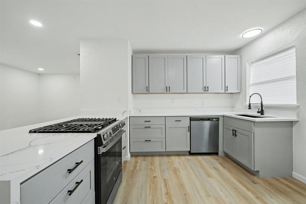 11446 Lippitt Avenue Dallas, TX 75218 - Photo 8 of 26 a kitchen with sink stove and cabinets