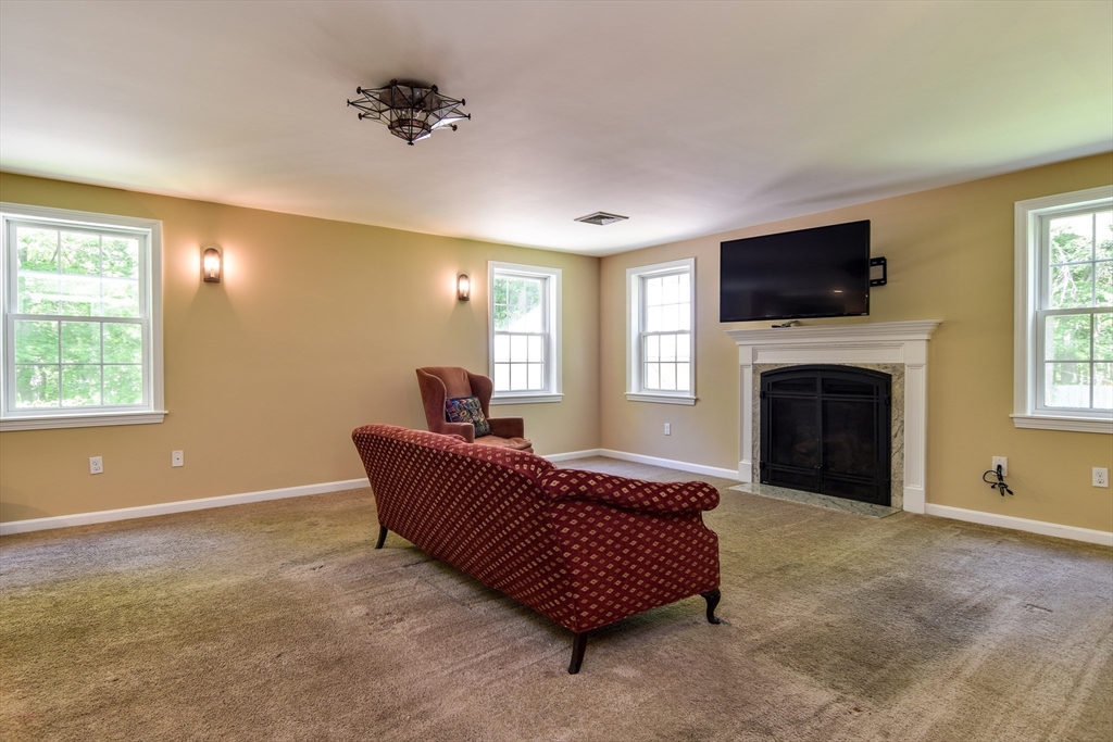 33 Grove Street Framingham, MA 01701 - Photo 10 of 33 a living room with furniture a flat screen tv and a fireplace