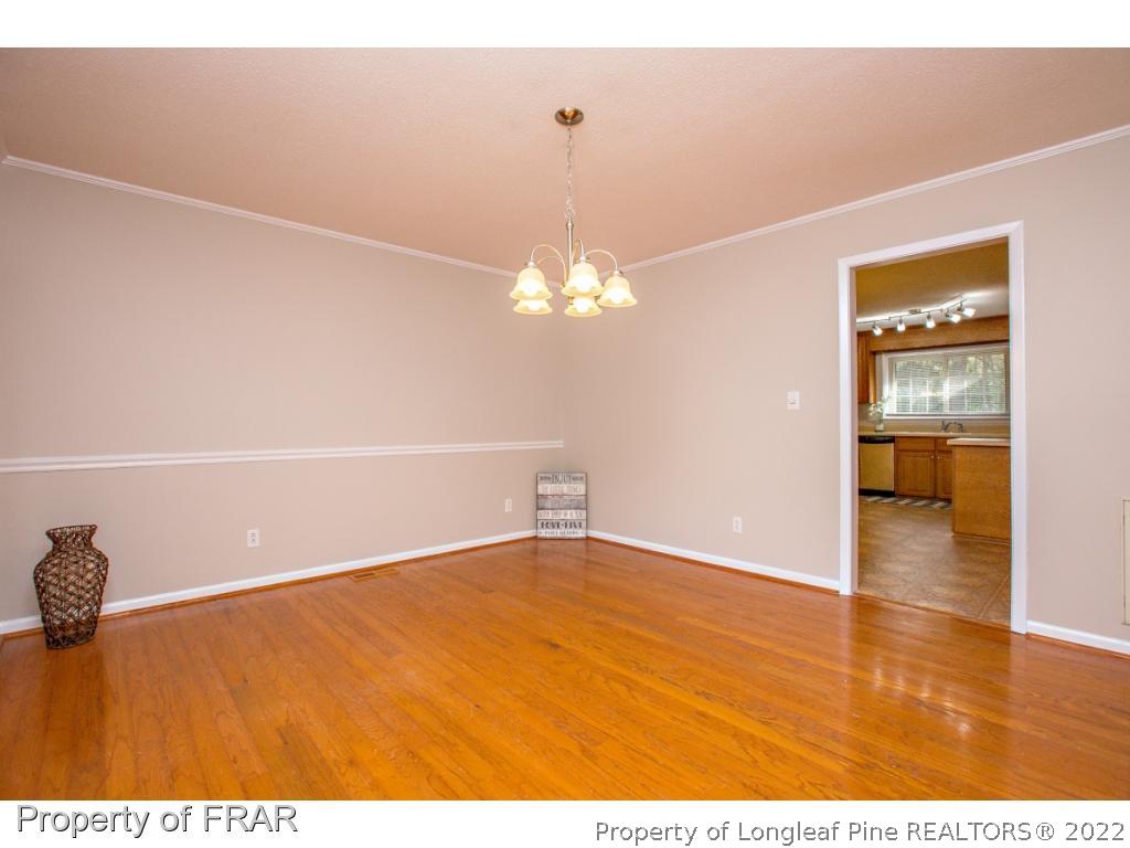 426 Hallmark Road Fayetteville, NC 28303 - Photo 11 of 36 a view of a room with wooden floor and chandelier