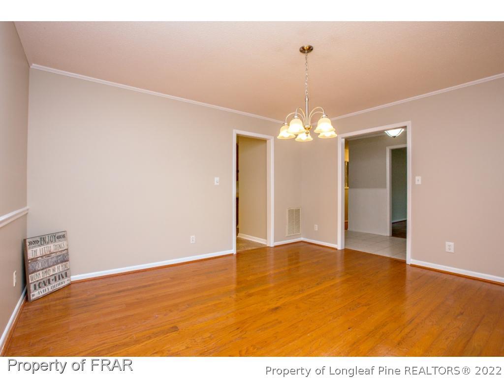 426 Hallmark Road Fayetteville, NC 28303 - Photo 13 of 36 a view of a chandelier in an empty room
