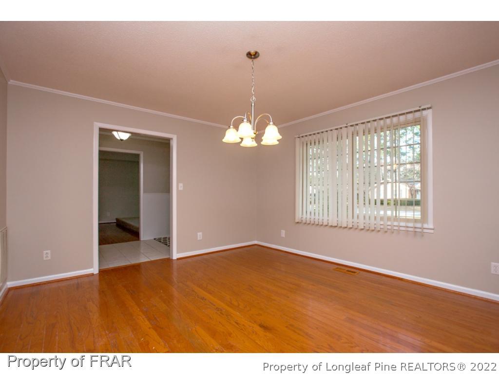 426 Hallmark Road Fayetteville, NC 28303 - Photo 14 of 36 a view of an empty room with window and wooden floor
