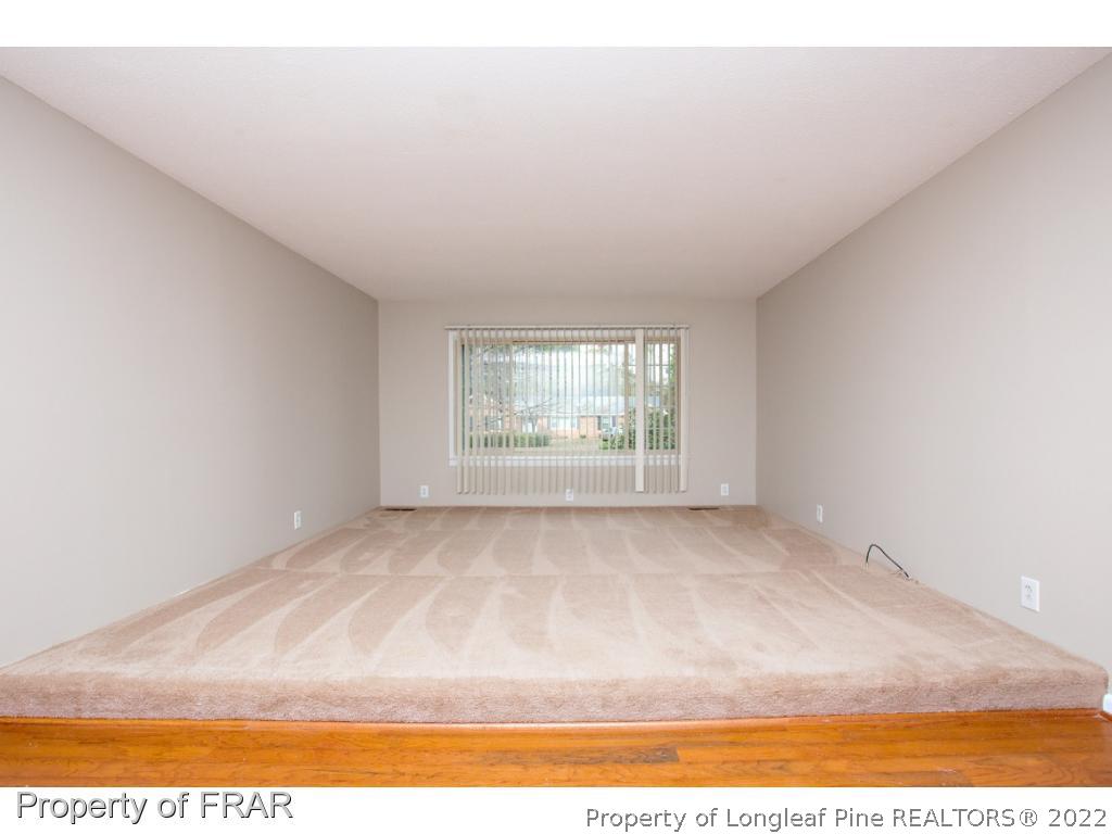 426 Hallmark Road Fayetteville, NC 28303 - Photo 16 of 36 a view of an empty room with wooden floor and a window