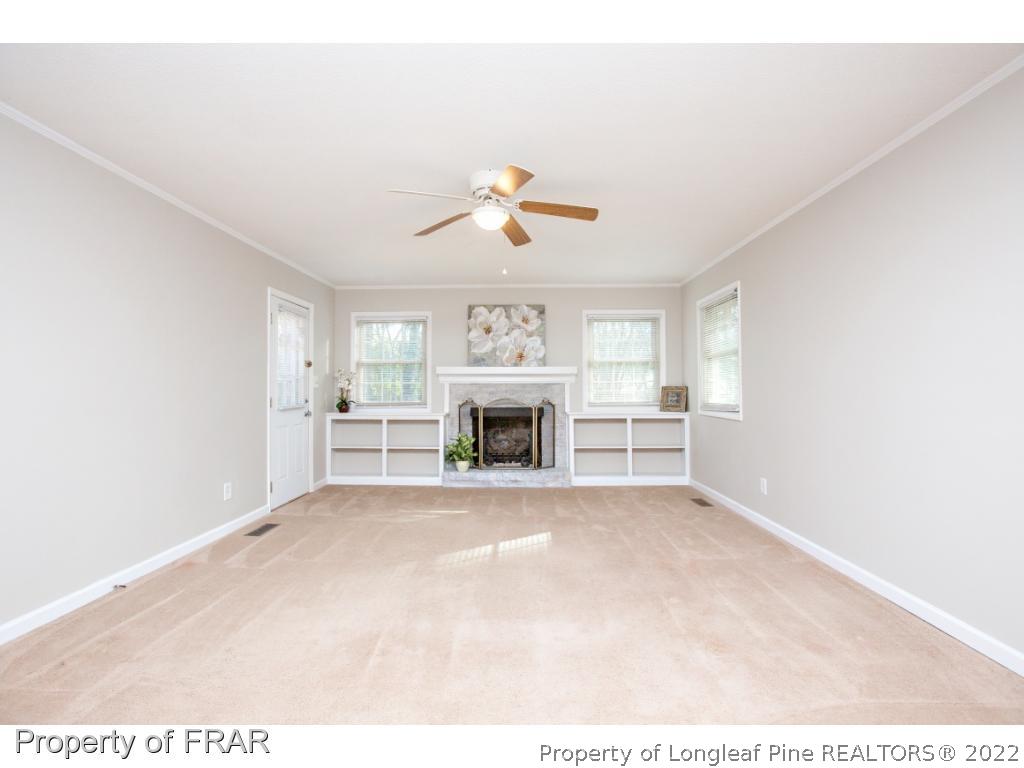 426 Hallmark Road Fayetteville, NC 28303 - Photo 2 of 36 a view of a livingroom with a fireplace and chandelier fan