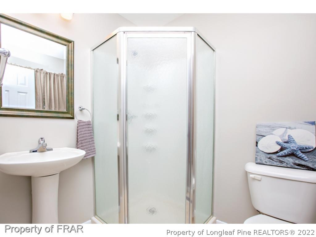 426 Hallmark Road Fayetteville, NC 28303 - Photo 29 of 36 a bathroom with a sink a toilet and shower