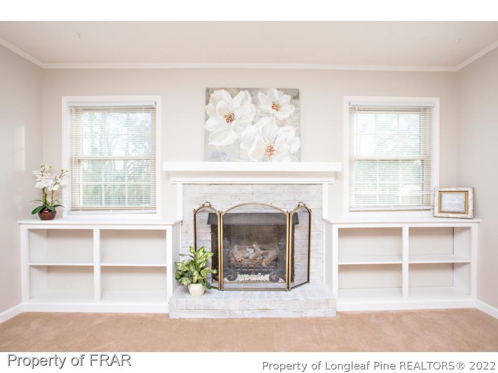 426 Hallmark Road Fayetteville, NC 28303 - Photo 3 of 36 a living room with a fireplace and a large window