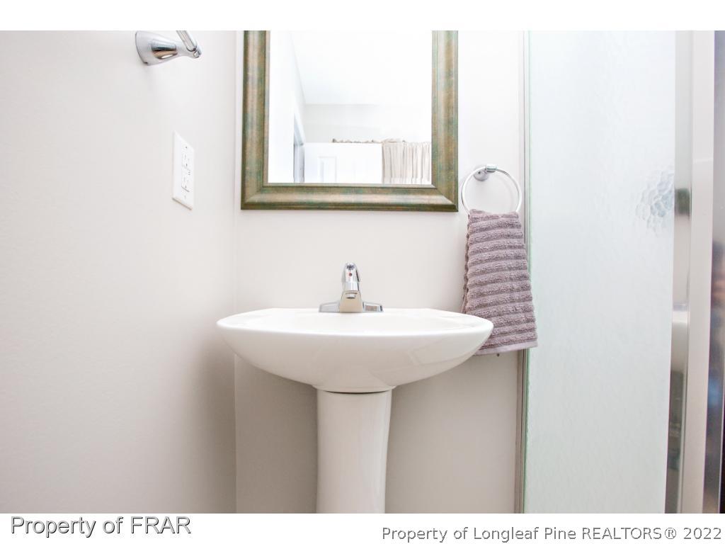 426 Hallmark Road Fayetteville, NC 28303 - Photo 31 of 36 a bathroom with a sink and a mirror