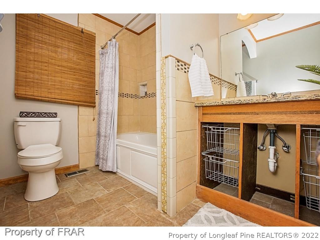 426 Hallmark Road Fayetteville, NC 28303 - Photo 33 of 36 a bathroom with a toilet sink and shower