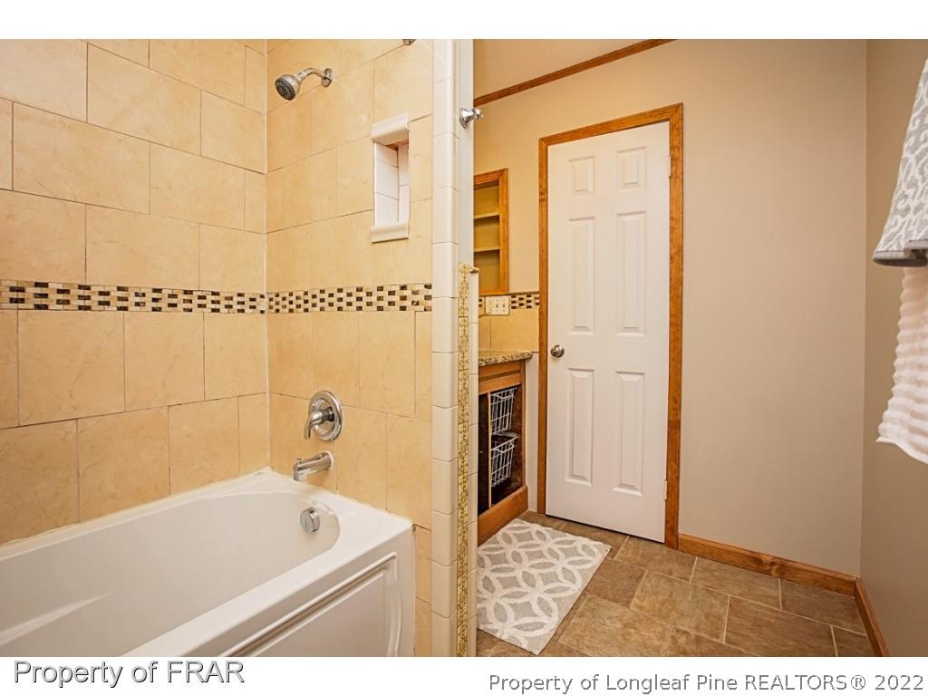 426 Hallmark Road Fayetteville, NC 28303 - Photo 34 of 36 a bathroom with a tub a sink and a shower