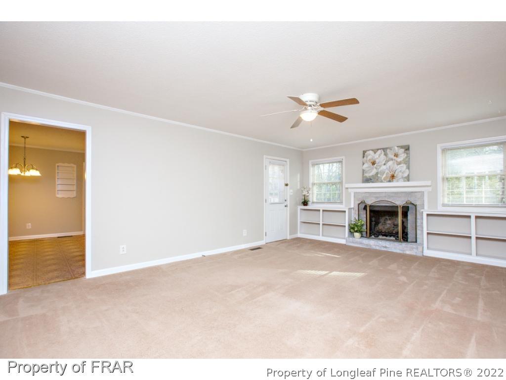 426 Hallmark Road Fayetteville, NC 28303 - Photo 5 of 36 a view of an empty room with a fireplace and a window