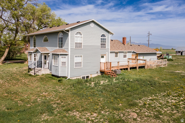 19994 South Olson Road Downey, ID 83234 - Photo 3 of 49 Back of property with a yard, a shingled roof, and a wooden deck