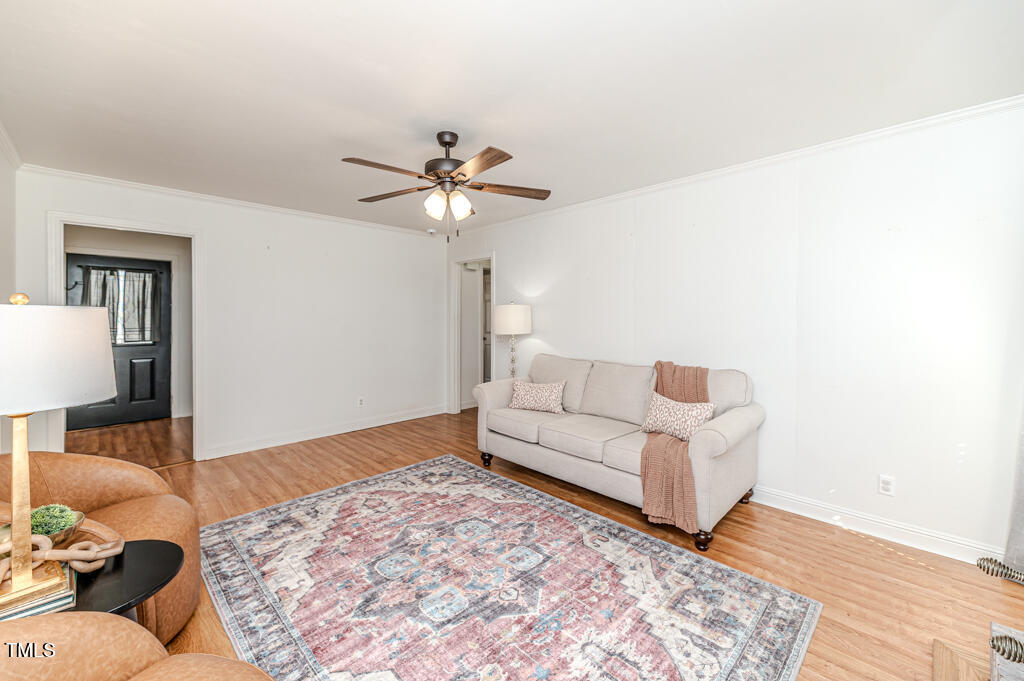 117 Johnson Street Broadway, NC 27505 - Photo 11 of 29 a living room with a bed furniture and a lamp