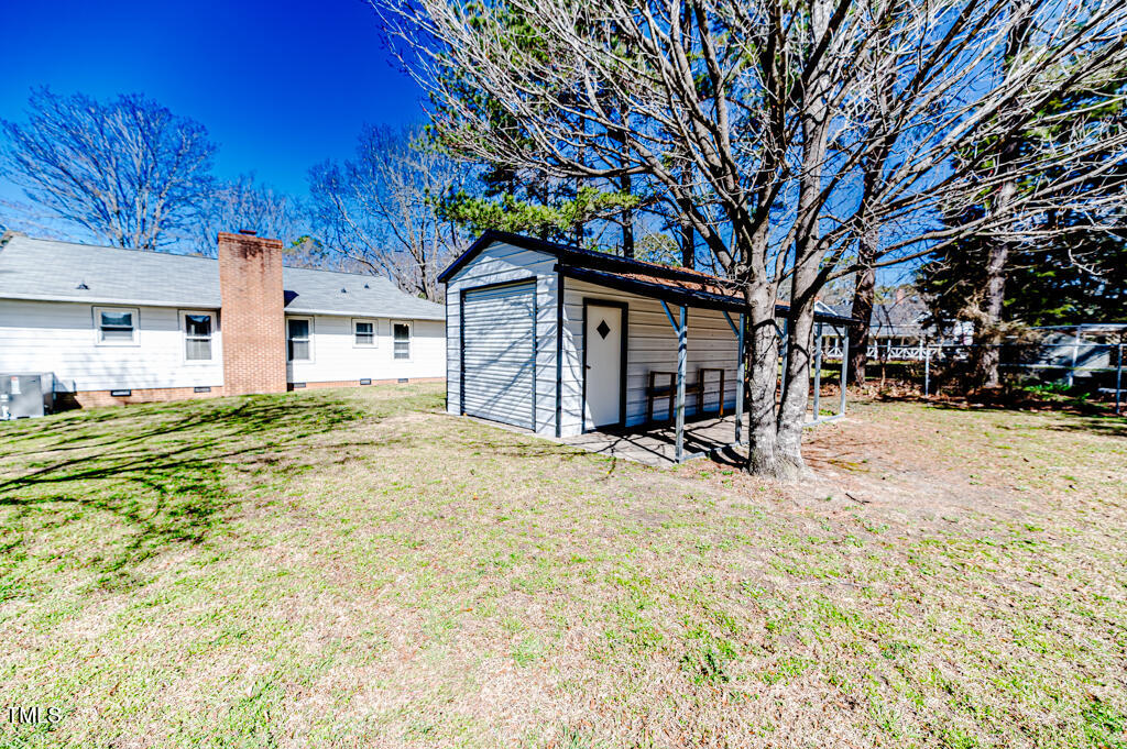 117 Johnson Street Broadway, NC 27505 - Photo 22 of 29 a view of a house with a yard covered in snow