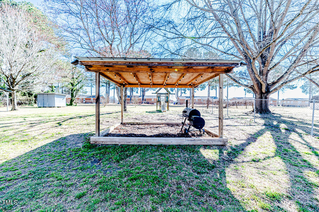 117 Johnson Street Broadway, NC 27505 - Photo 24 of 29 a view of a backyard with large tree