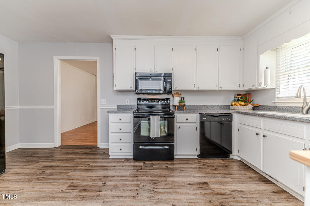 117 Johnson Street Broadway, NC 27505 - Photo 8 of 29 a kitchen with granite countertop a stove and cabinets