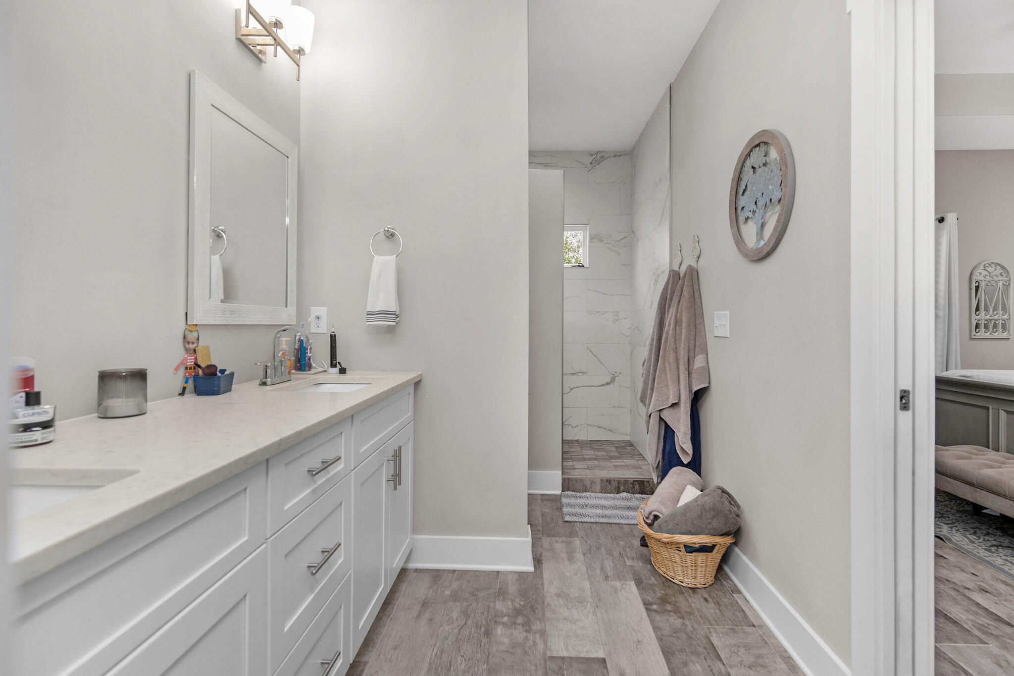 8914 Timber Lane Navarre, FL 32566 - Photo 22 of 40 a spacious bathroom with a double vanity sink and a mirror